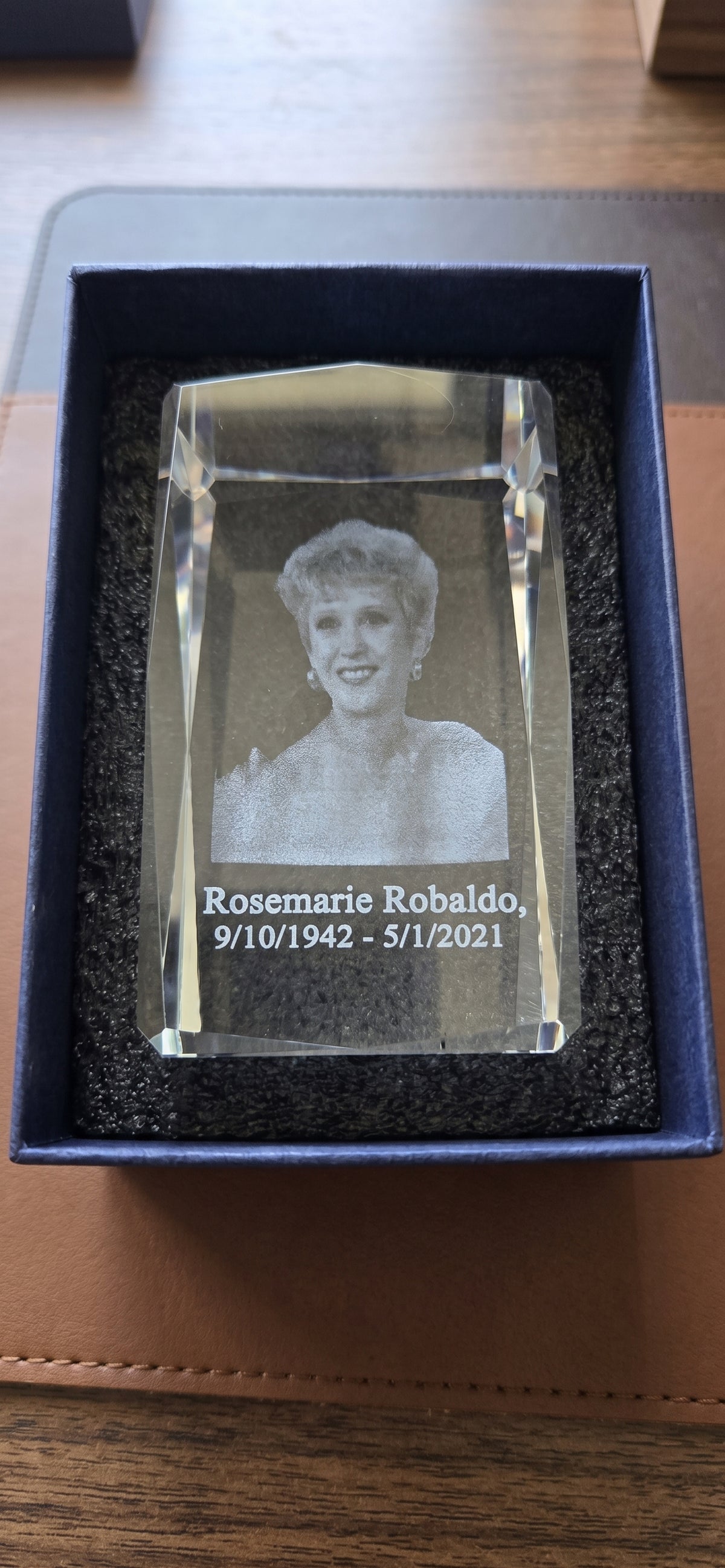 Custom 3D photo crystal with portrait, name and dates laser engraved inside the glass, padded in foam inside a blue presentation box